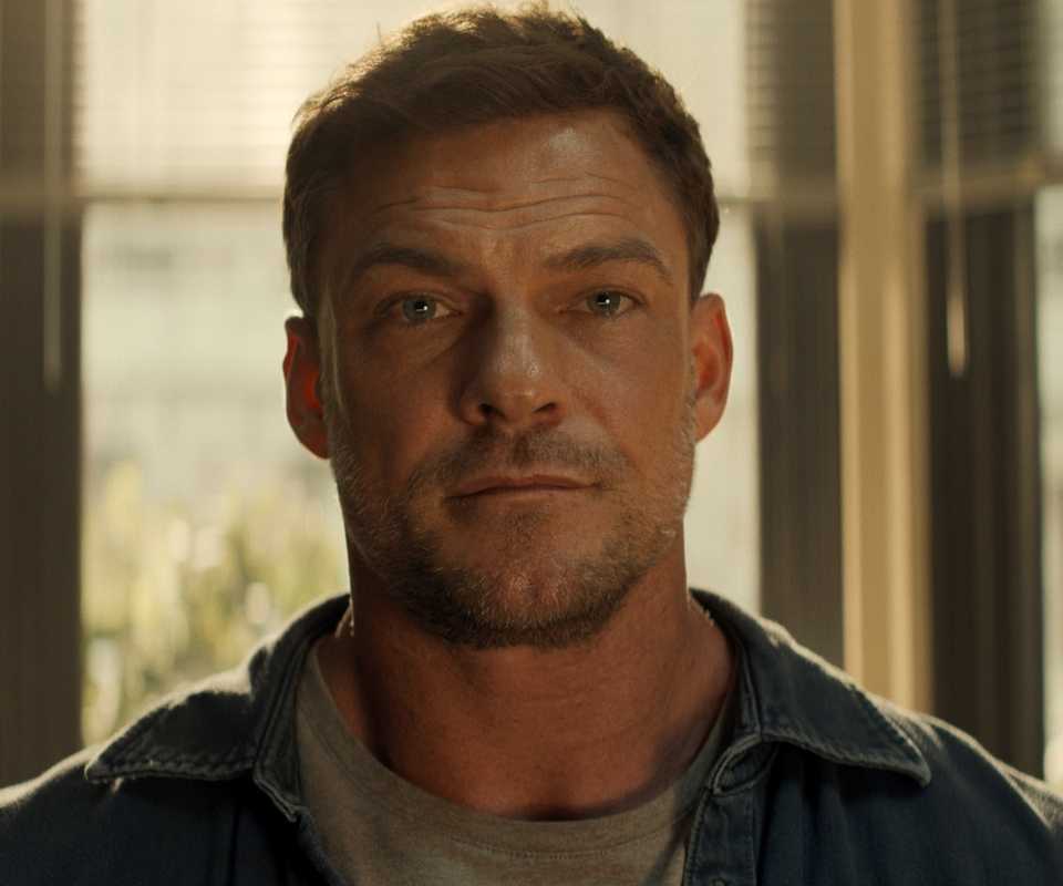 Alan Ritchson as Jack Reacher looking curious in Reacher Season 4