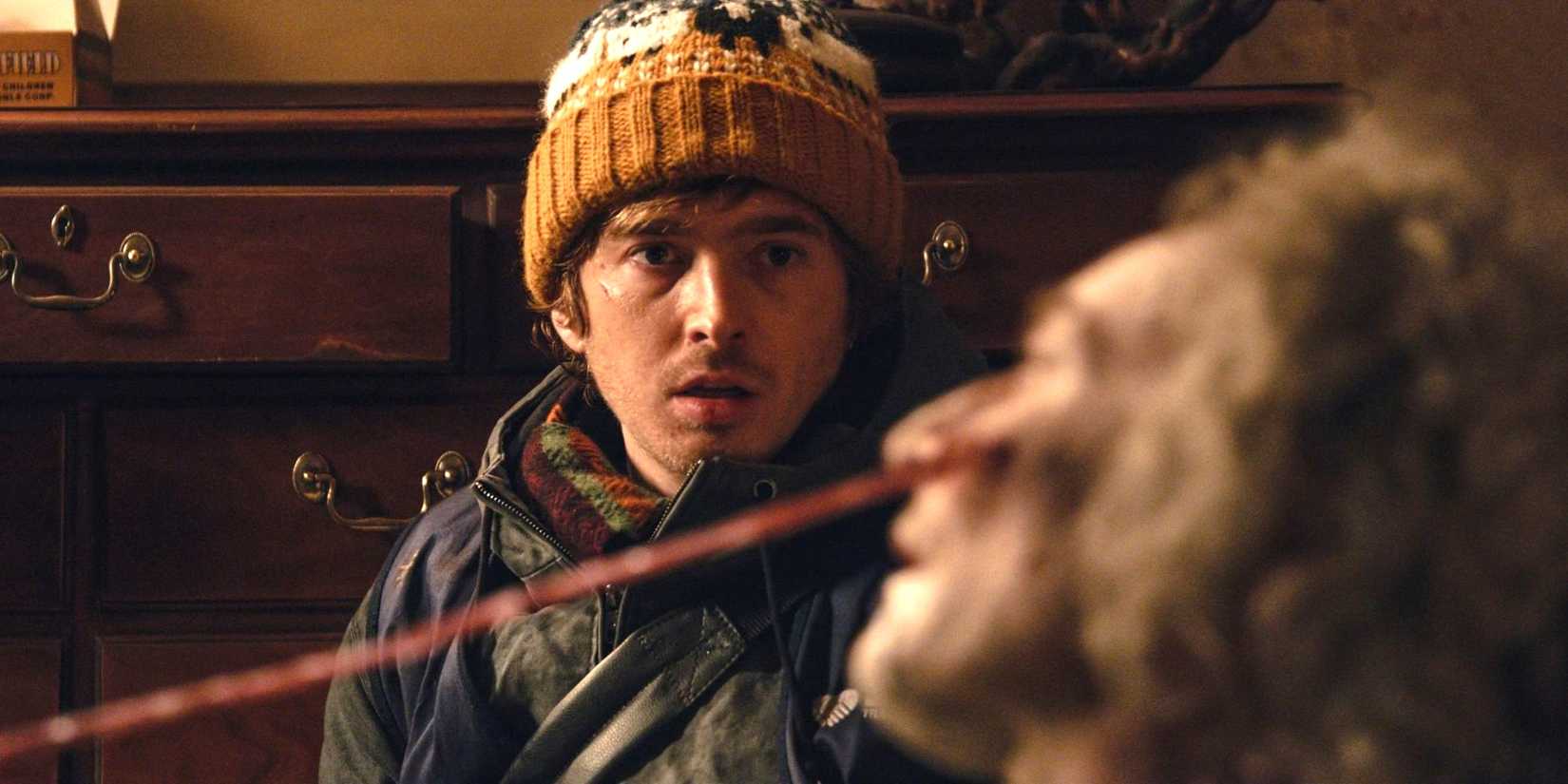 Austin Abrams as Bryan staring at an infected person in Resident Evil.