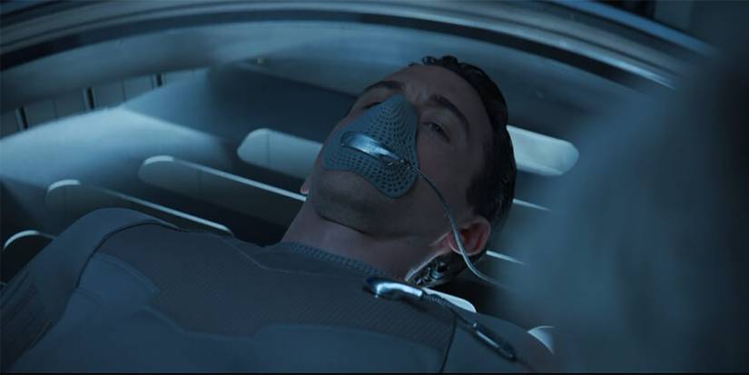 Troy lying with a mask being waken from a cryogenic sleep in Silo.
