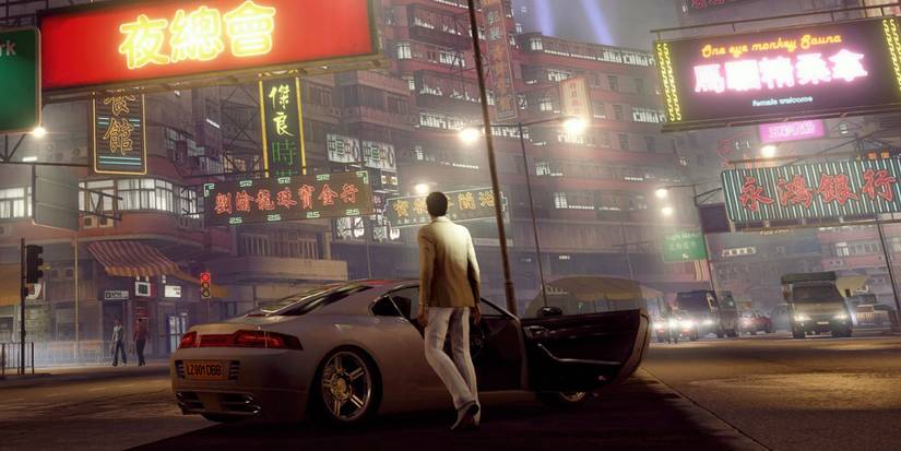 Sleeping Dogs screenshot of Wei Shen in a white suit next to a white car in Hong Kong
