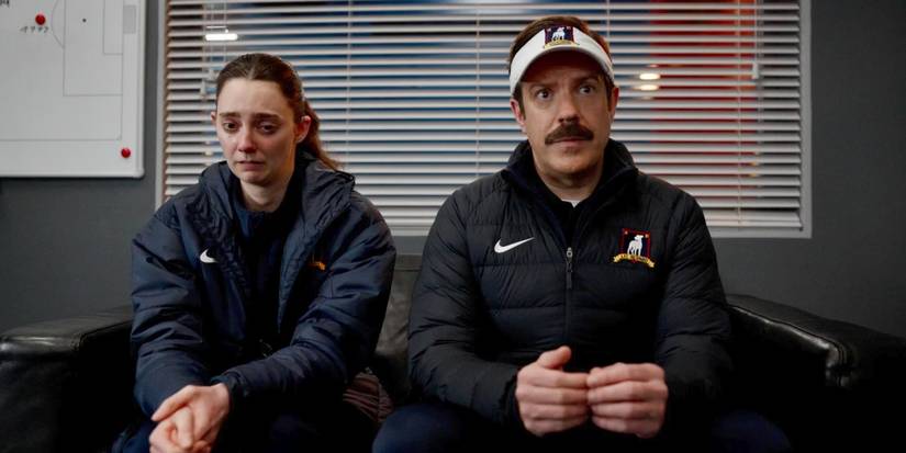 Alice Chilton (Tanya Reynolds) cries and Ted (Jason Sudeikis) sits next to her in Ted Lasso Season 4