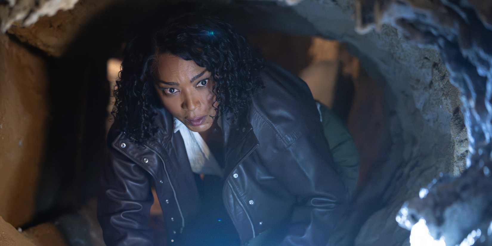 Athena Grant crawling through a tunnel in the Season 10 premiere of 9-1-1
