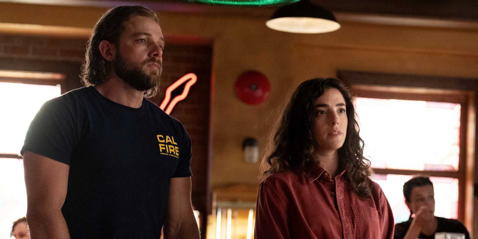 Olivia Thirlby as CJ standing next to Max Thieriot as Bode inside of Smokey's in Fire Country