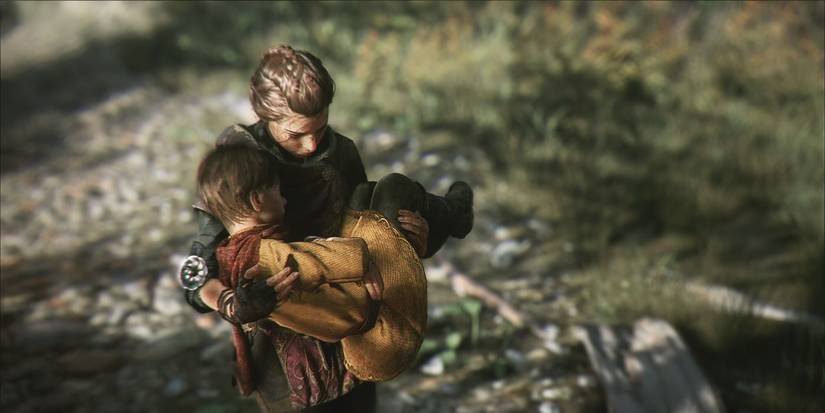 Amicia holds Hugo in a forest scene from the game A Plague Tale: Innocence.