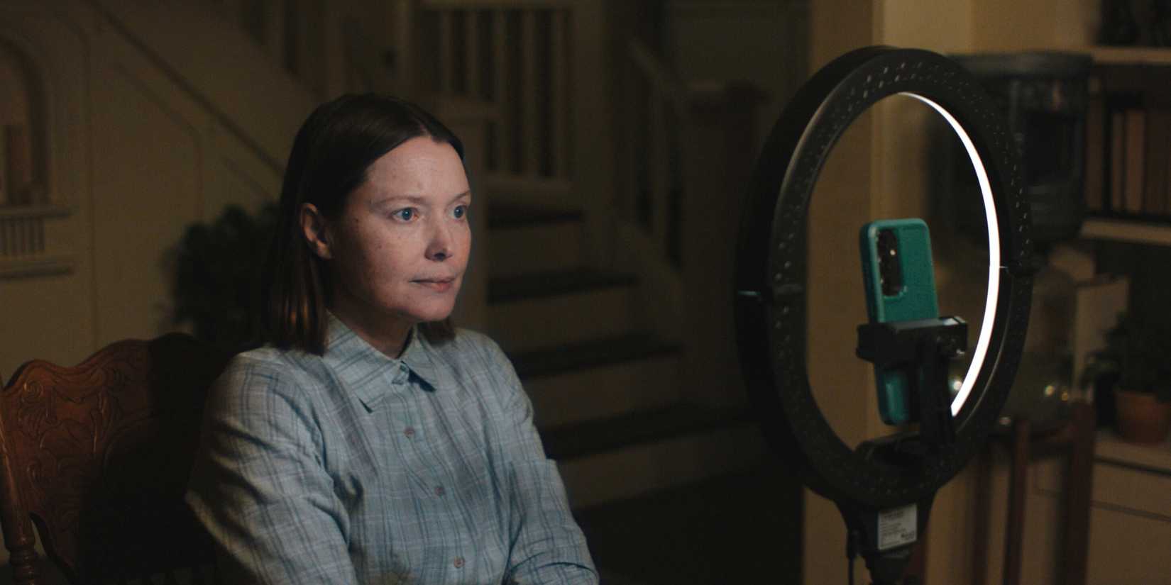 Samantha Sloyan as Margaret White records a video in front of a ring light in 'Carrie.'