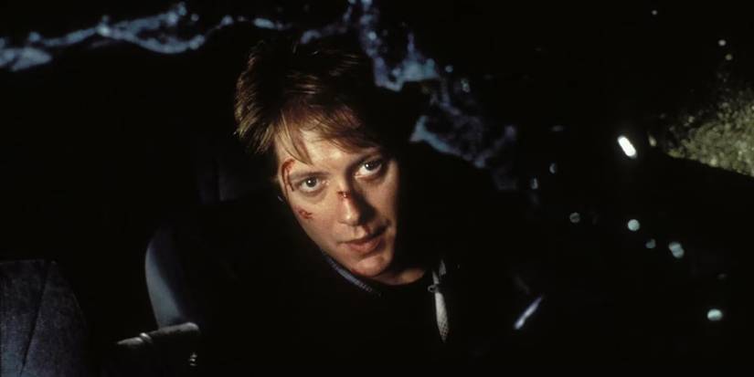 James Spader with cuts on his face looking out a broken windshield in Crash