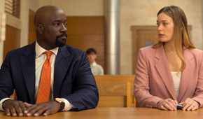 Mike Colter as Michael Price sitting next to Rachel Keller as Olivia Siffre in court in Cupertino