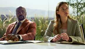 Mike Colter as Michael Price sitting next to Rachel Keller as Olivia Siffre in their office in Cupertino