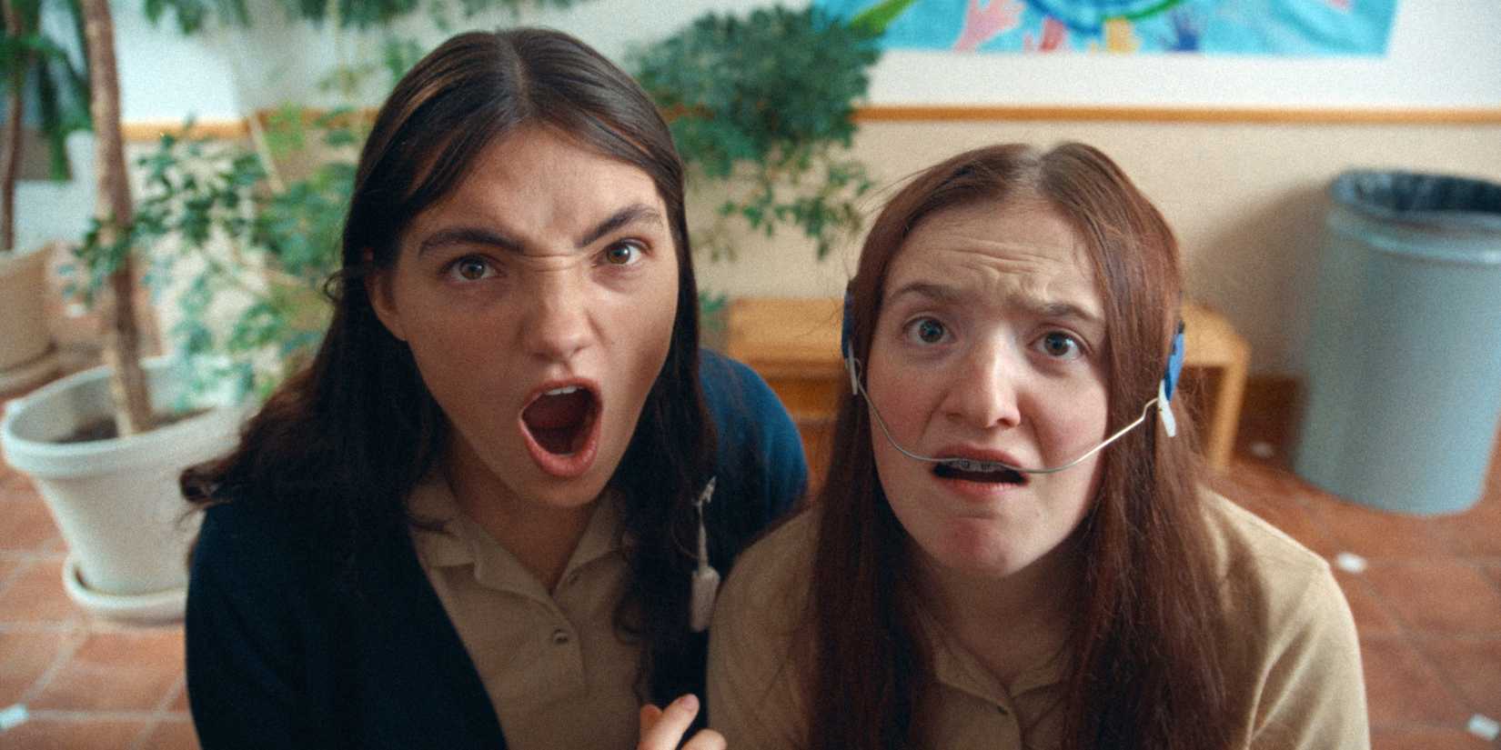 Adi Madden Cabrera as Edie with her mouth open next to McKenna Tuckett as Frances in Edie Arnold is a Loser