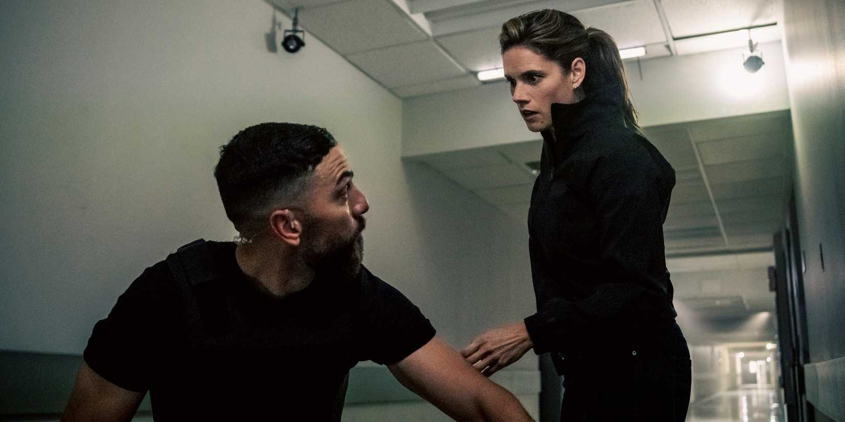 Missy Peregrym as Maggie standing over a crouched down Zeeko Zaki as OA in FBI Season 9