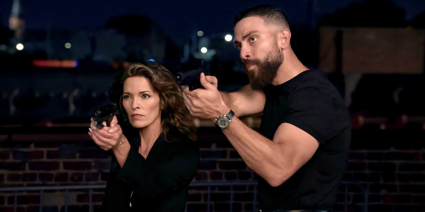 Zeeko Zaki as OA standing alongside Alana de la Garza as Isobel with their guns drawn in FBI Season 9