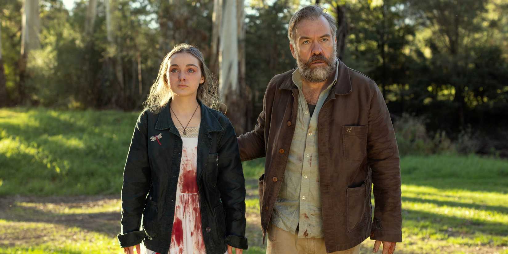 Brendan Cowell as Henry with Chloe Jean Lourdes as Sarah wearing a dress covered in blood in Last Seen