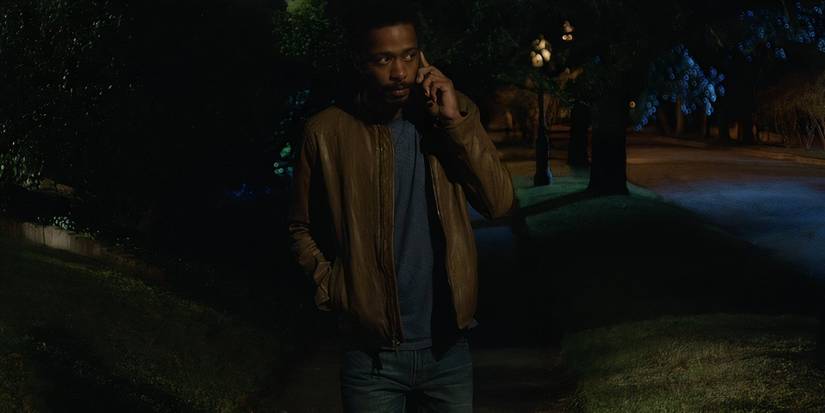 Lakeith Stanfield walks alone in the suburbs at night in Get Out.