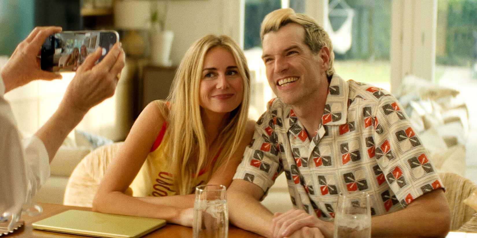 Morgan (Justine Lupe) and Sasha (Timothy Simons) posing for a picture together in 'Nobody Wants This' Season 3.