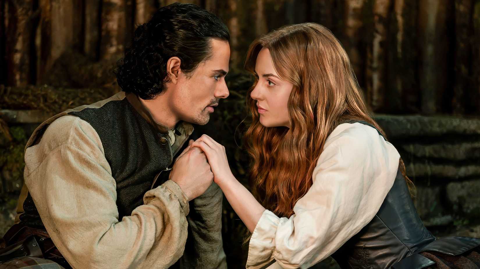 Jamie Roy as Brian holding the hand of Harriet Slater as Ellen in Outlander: Blood of My Blood Season 2