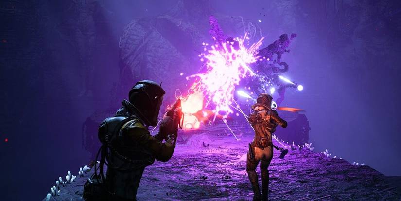 People in spacesuits shooting at monsters in 'Returnal'
