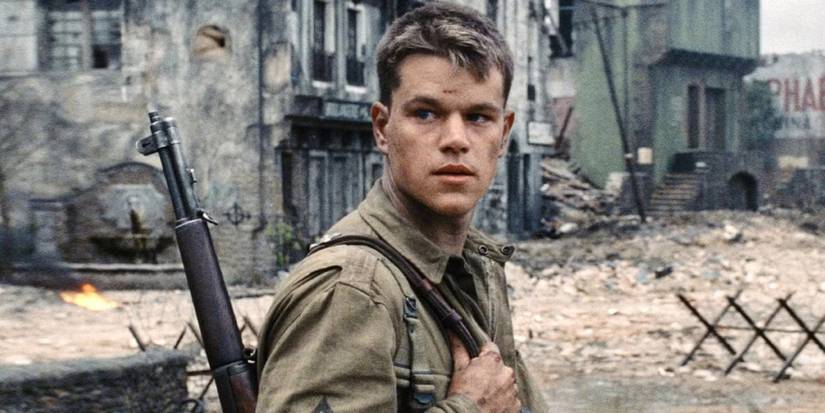 Private Ryan in a war-torn town, looking back at something off camera in Saving Private Ryan (1998).