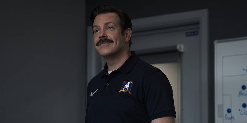 Ted smiling at someone in Ted Lasso.
