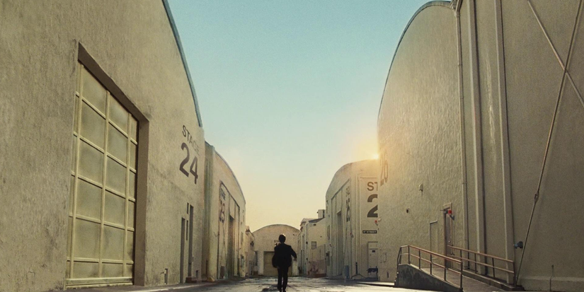 A man walks through a studio lot