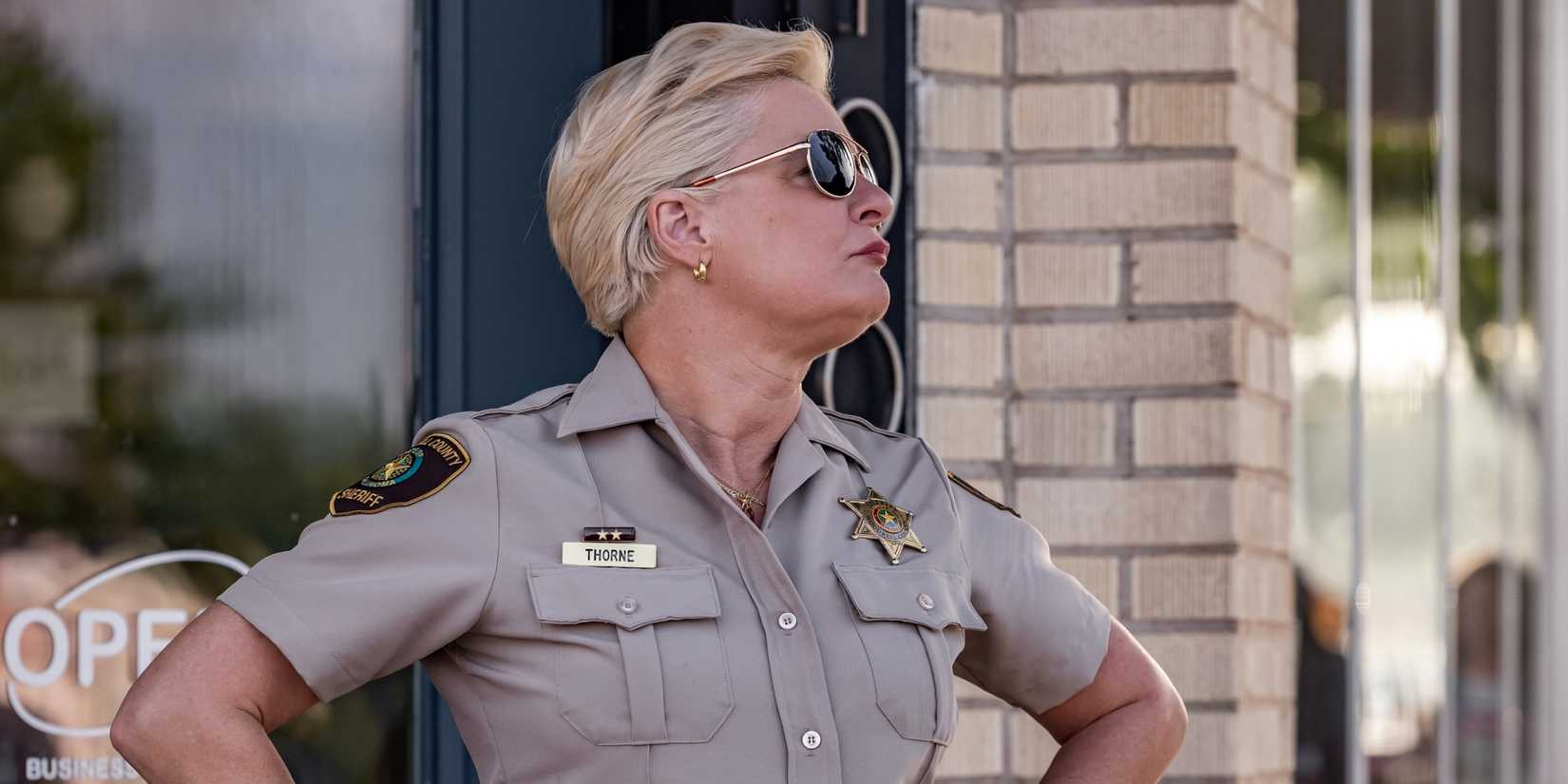Martha Plimpton as Sheriff Vela Thorne standing outside in uniform in The Lowdown Season 2