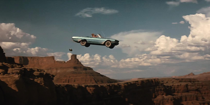A convertible car leaps over canyons