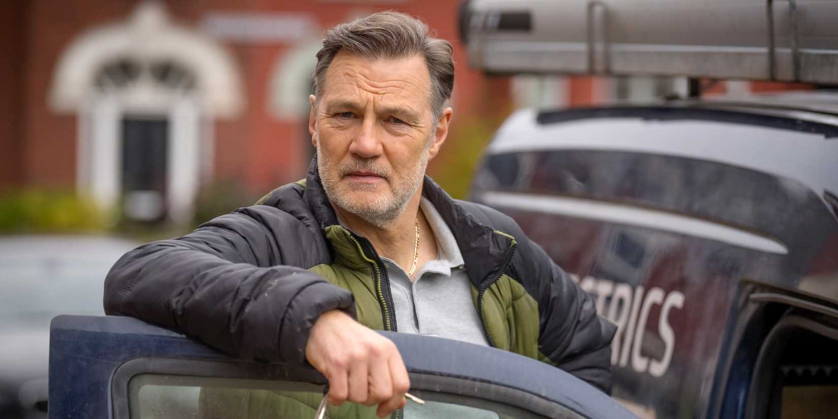 David Morrissey as Clive Goss leaning his arm on the top of his car door in Tip Toe
