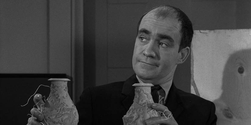 A man holding out two antiques in 'The Twilight Zone' episode "I Dream of Genie"