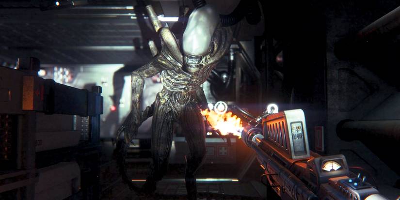 First-person view of the player shooting at a xenomorph in Alien Isolation