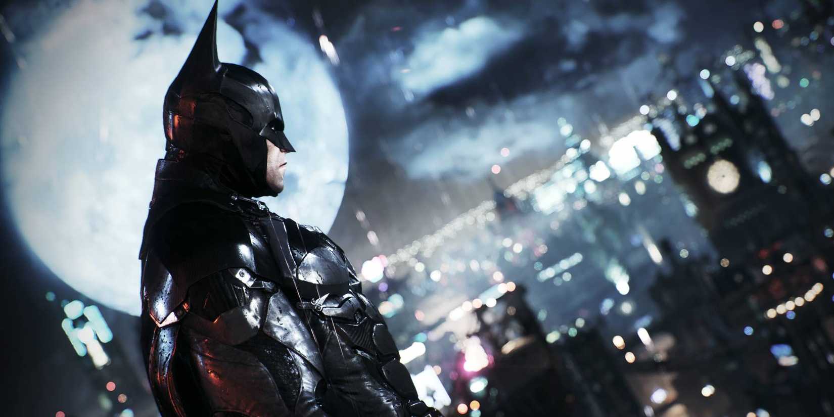 Batman atop a building looking down at Gotham in Batman: Arkham Knight