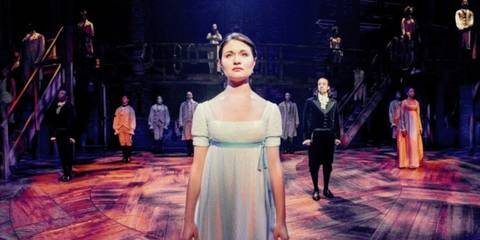eliza-under-the-spotlight-with-the-rest-of-the-cast-spaced-across-the-stage-behind-her-in-the-hamilton-finale.jpg