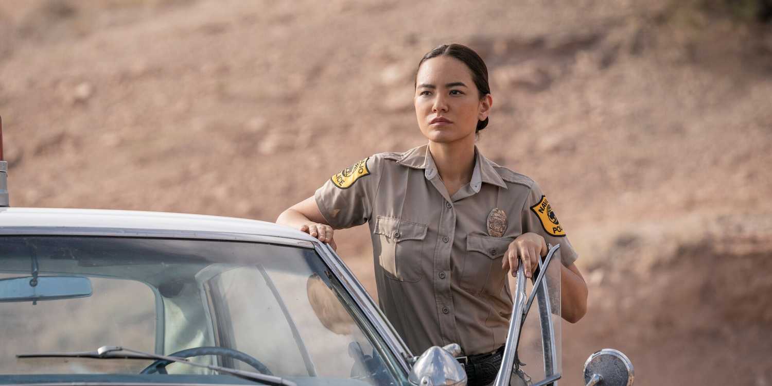 Jessica Matten is standing outside a cop car in Dark Winds.