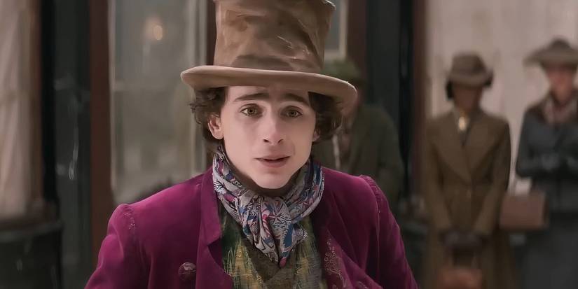 Timothée Chalamet as Willy Wonka in a top hat looking disappointed on a city street in Wonka