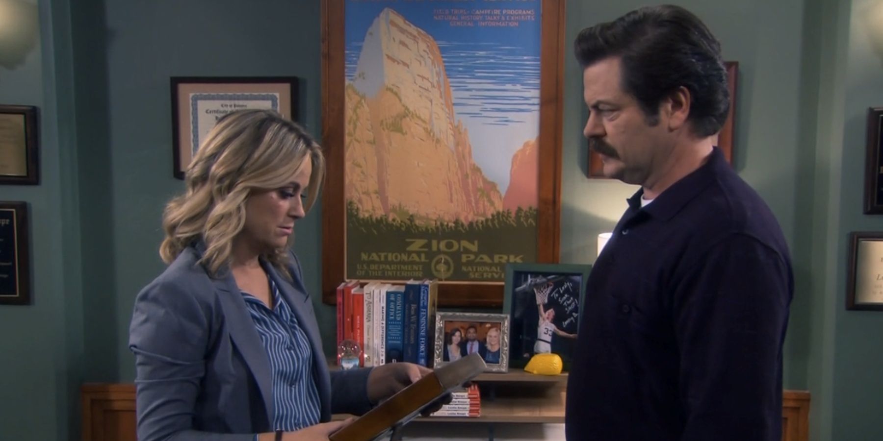 leslie-and-ron-looking-at-a-frame-in-parks-and-recreation.jpg