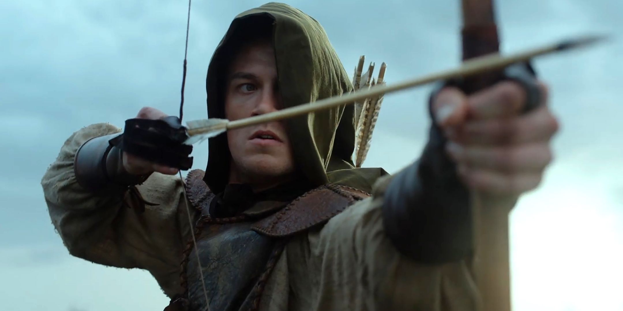 jack-patten-as-rob-drawing-an-arrow-while-his-face-in-covered-in-a-hood-in-robin-hood.jpg