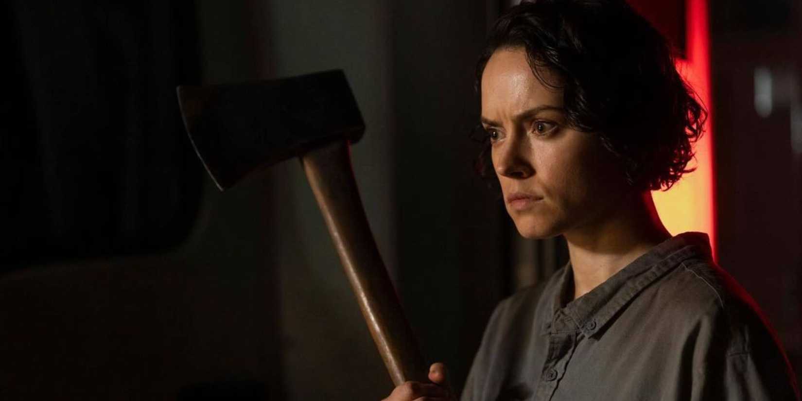 Daisy Rdley holding an axe in We Bury the Dead