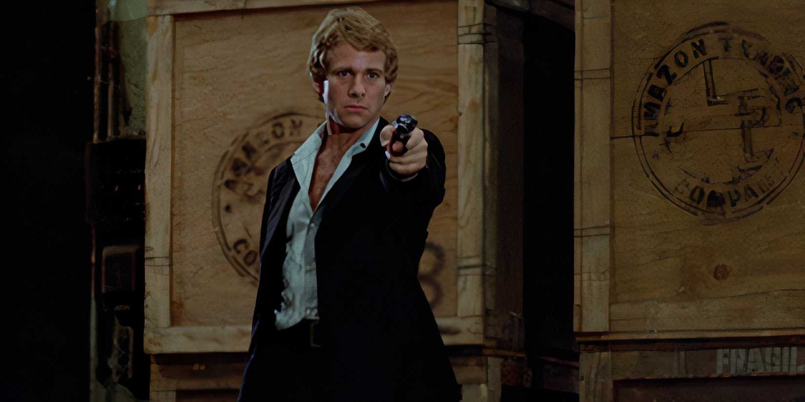 Ryan O'Neil aiming a gun in The Driver