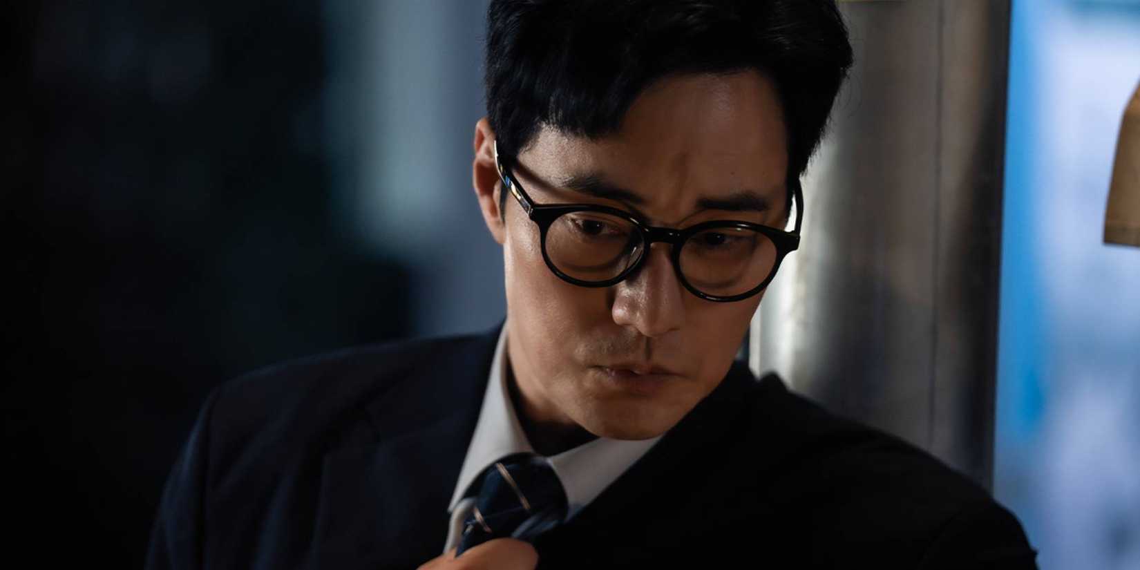 So Ji-sub in a suit looking at something off-screen.